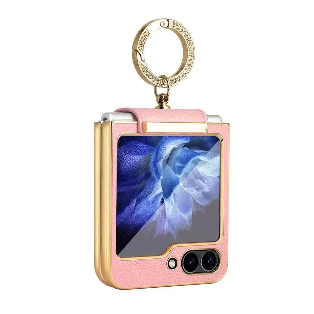Pink and gold foldable smartphone case with blue floral screen and embellished keyring