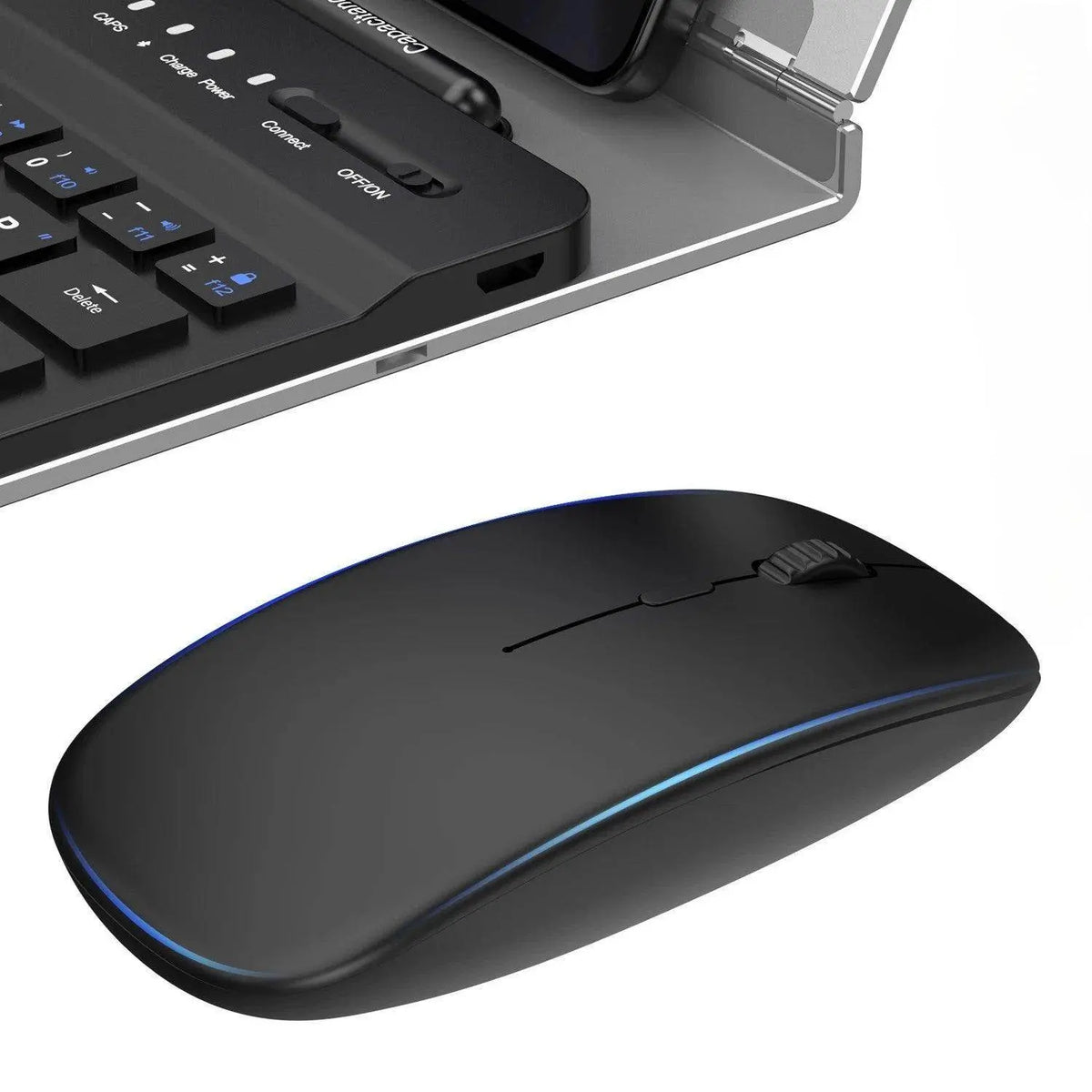 Black wireless computer mouse with blue LED accents next to a laptop keyboard